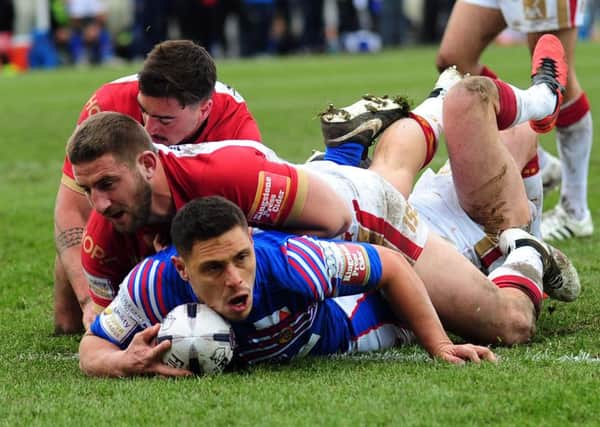 Wakefield's Anthony Tupou goes over to score their first try.
