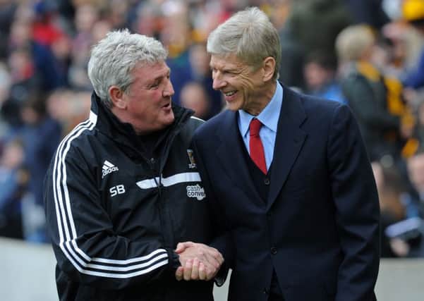 Steve Bruce and Asene Wenger shake hands before kick off during a 2014 Premier League encounter. (Picture: Bruce Rollinson)
