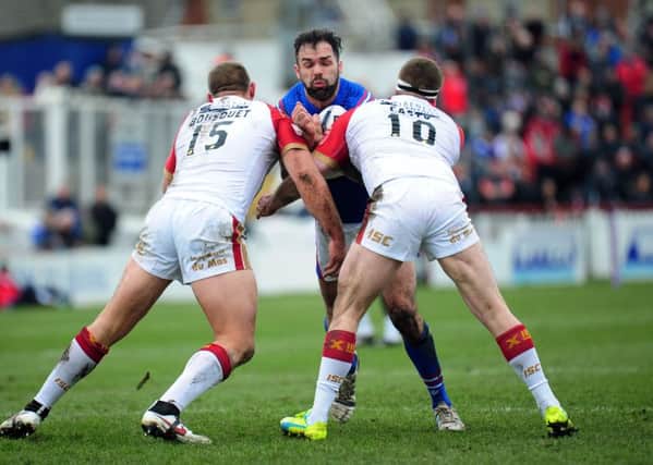 Wakefield Trinity Wildcats' Anthony England is tackled by Catalan's Julian Bousquet and Remi Casty. 
Picture: Jonathan Gawthorpe