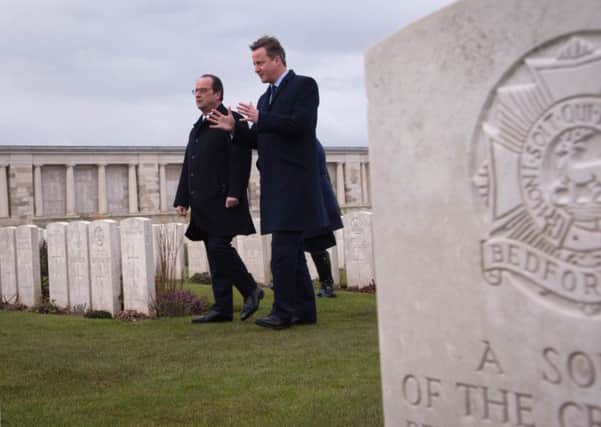 Prime Minister David Cameron (right) and French President Francois Hollande visit Poizeres Cemetery near the town of Amiens.