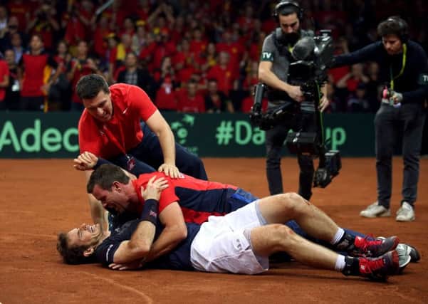 Great Britain's Andy Murray is mobbed by captain Leon Smith after beating David Goffin to win the Davis Cup Final at the Flanders Expo Centre in Ghent last November. Picture: PA.