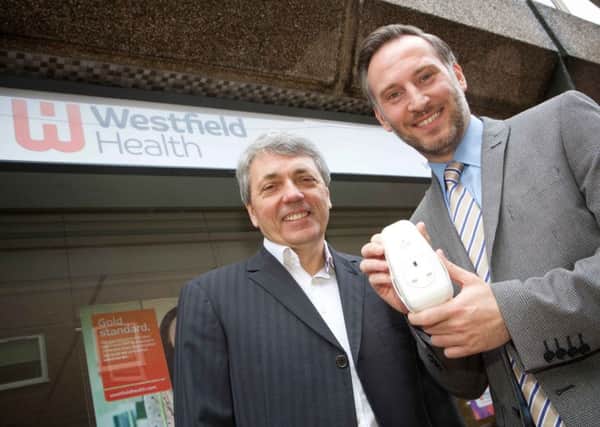 Steve Purdham (3rings) and David Capper (Westfield Health) with 3rings plug outside Westfield Health in Sheffield