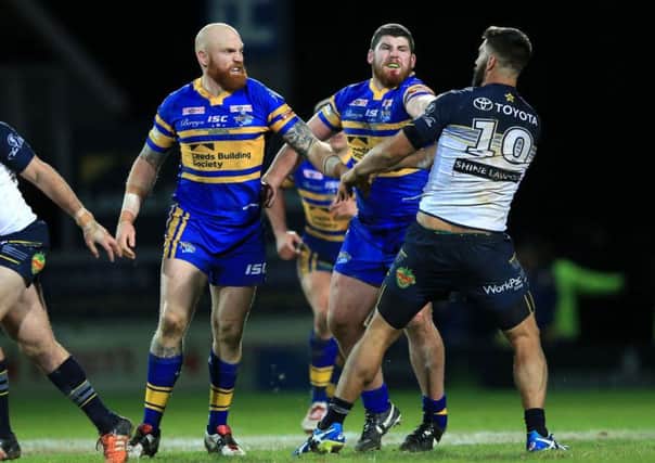 SEEING RED: Leeds Rhinos' Mitch Garbutt, second right, punches North Queensland Cowboys James Tamou, resulting in a red card during the World Club Series match at Headingley last month. Picture: PA.