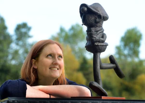Harriet Hunter Smart, curator of the Garden Rooms at Tennants Auctioneers, Leyburn, with a  bronze figure of Andy Capp by sculptor Myles Meehan, one of the items from the Reg Smythe collection of Andy Capp memorabilia which is being auctioned. (Gl1007/64b)