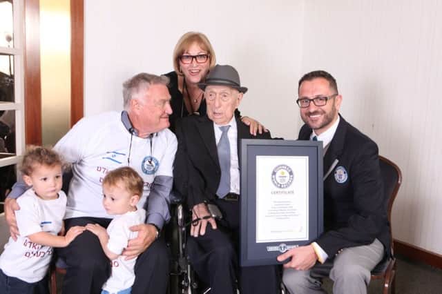 Grandchildren Nevo (left)and Omer, Heim Kristal (son), Shula Kuperstoch (daughter) with Marco Frigatti, Head of Records for Guinness World Records and 112-year-old Israel Kristal