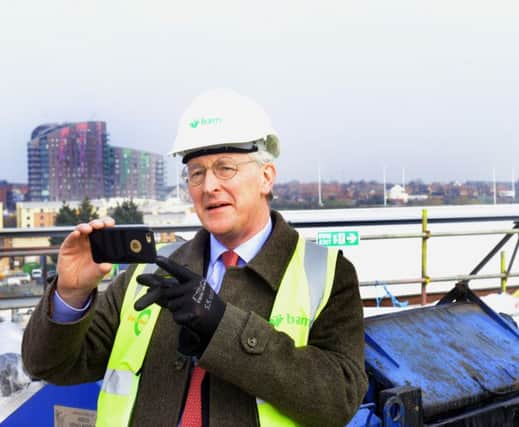 Hilary Benn MP  taking a photo from the roof of the new UTC in Leeds which is due to open in September.