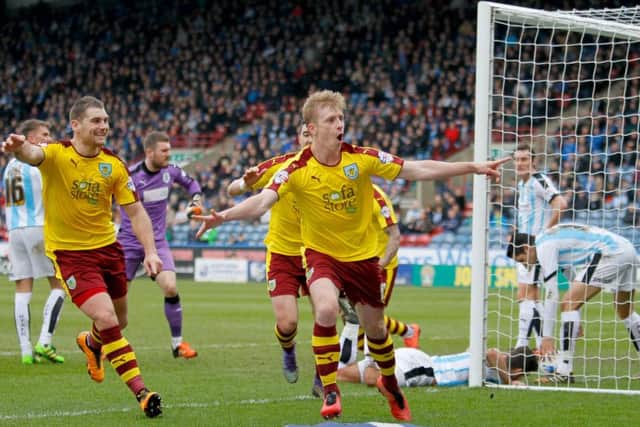 Burnley's Ben Mee (right) celebrates scoring his side's third goal of the game during the Sky Bet Championship match at the John Smith's Stadium, Huddersfield.
