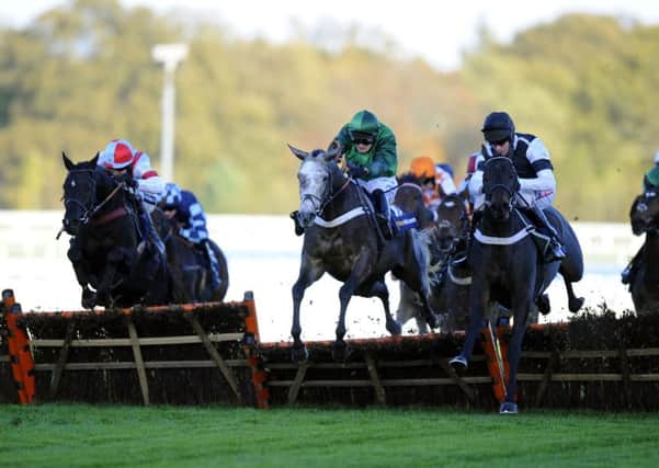 Jockey Barry Geraghty, right, jumps the last on Sign of a Victory to go on and win the William Hill Handicap Hurdle at Ascot in November 2014 (Picture: Andrew Matthews/PA Wire).
