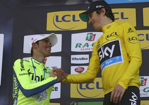 Winner of the Paris-Nice cycling race, Geraint Thomas of Great Britain, right, shakes hands with Alberto Contador of Spain. (AP Photo/Lionel Cironneau)