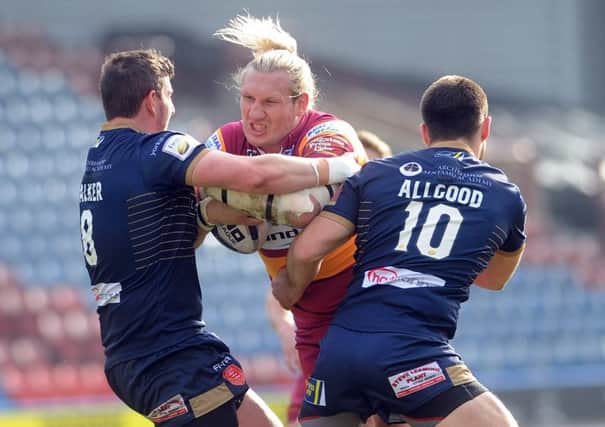 Eorl Crabtree breaks past the challenge of Adam Walker and Mitch Allgood on Sunday. (Picture: Simon Hulme)