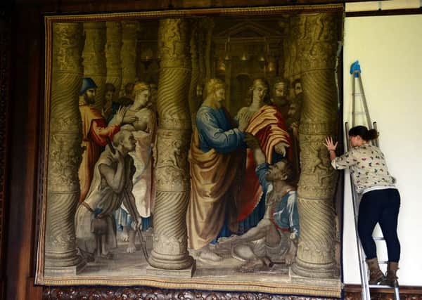 Staff member Amy Secker re-installs one of the 16th century Mortlake Tapestries in the State Drawing Room at Chatsworth following a two year restoration. Picture Scott Merrylees