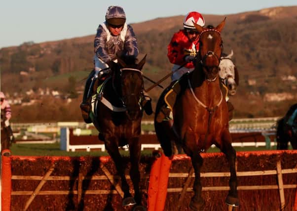 The New One, ridden by Sam Twiston-Davies, right, jumps the last with Vaniteux, ridden by Barry Geraghty, left, in the StanJames.com International Hurdle at Cheltenham (Picture: David Davies/PA Wire).