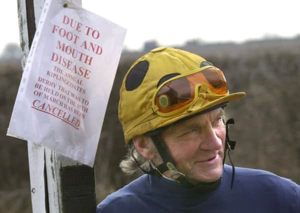 Ken Holmes pictured by the foot and mouth sign saying the Kiplingcoates Derby is cancelled, Ken came second in the race on Cassius.
