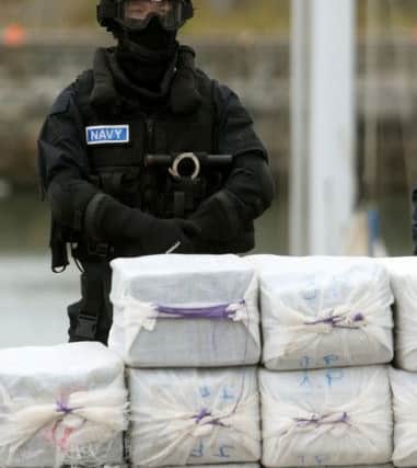 A member of the navy stands behind what is believed to be around 80 million euro (Â£62.5 million) worth of cocaine which was taken from onboard the yacht Makayabella
