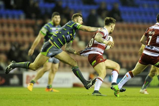Zak Hardaker closes in on Oliver Gildart during Leeds Rhinos' defeat to Wigan Warriors. Picture: Bruce Rollinson.