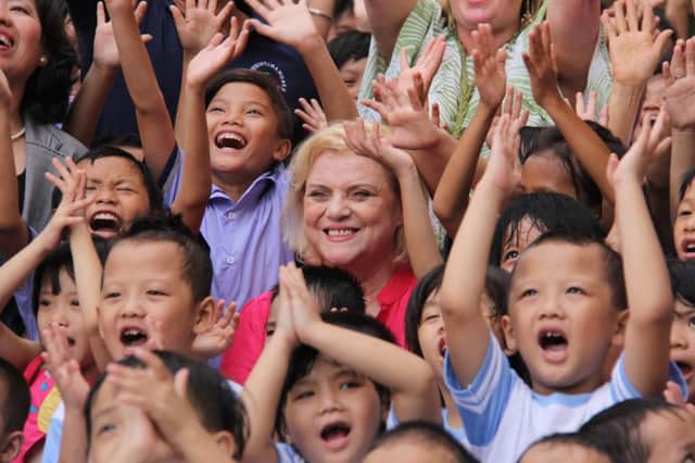 Christina Noble in Vietnam with some of the 700,000 children she has helped through her foundation.