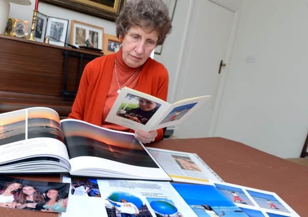 Jenny Allen looking through photographs of her daughter Stephanie who lost her battle with anorexia.