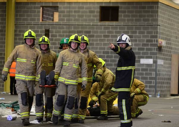 Fire crews take part in a large scale training excercise at the West Yorkshire Police training complex at Carr Gate in Wakefield. Pictures: Scott Merrylees.
