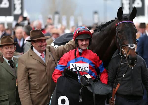 Nico de Boinville (centre) celebrates with Trainer Nicky Henderson (second from left) after winning the Betway Queen Mother Champion Chase with Sprinter Sacre on the second day of the Cheltenham Festival. Picture: David Davies/PA.