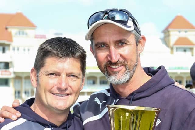 Martyn Moxon, with head coach Jason Gillespie cand the 2014 County Championship trophy. Picture: SWPIX.COM
