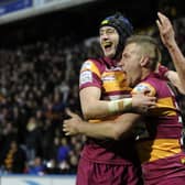 Sam Wood, left, helps Jamie Foster celebrate his try for Huddersfield Giants against Wigan Warriors last month (Picture: Bruce Rollinson).