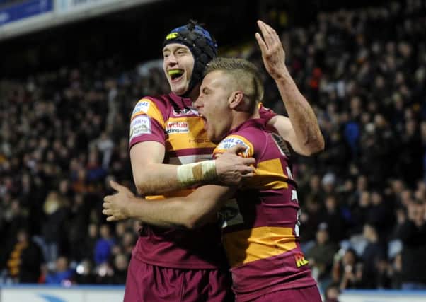 Sam Wood, left, helps Jamie Foster celebrate his try for Huddersfield Giants against Wigan Warriors last month (Picture: Bruce Rollinson).