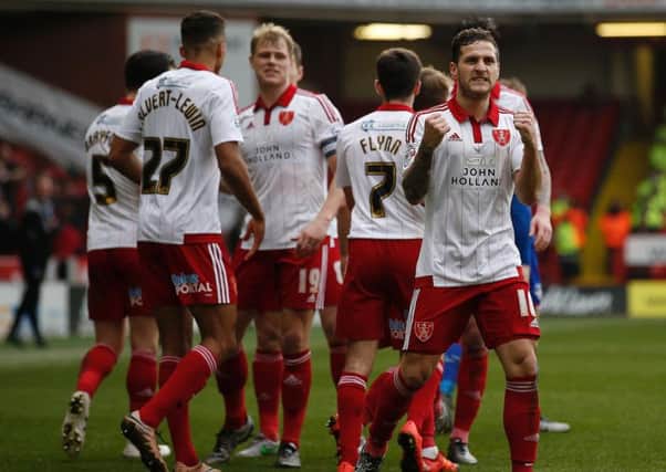 Billy Sharp and his Sheffield United team-mates celebrate the third goal against Oldham.