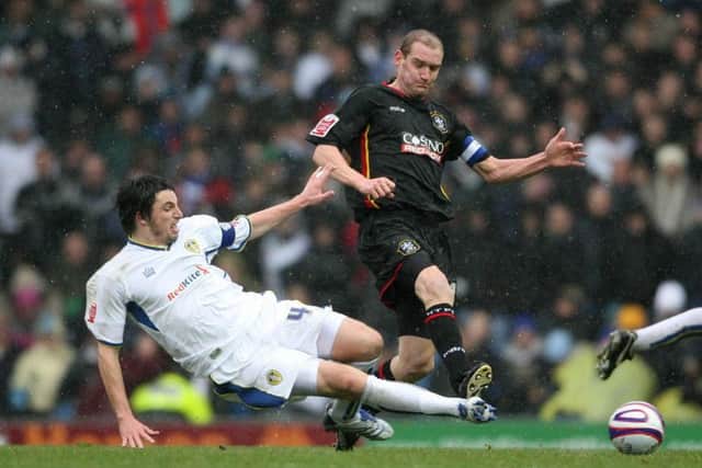 Leeds United's Jonathan Douglas tackles Huddersfield Town's Andy Booth during a League One derby at Elland Road in December 2007.