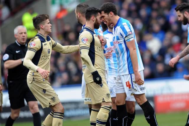 Leeds United's Mirco Antenucci and Huddersfield's Mark Hudson clash during last January's encounter at John Smith's Stadium.  Picture: Jonathan Gawthorpe.