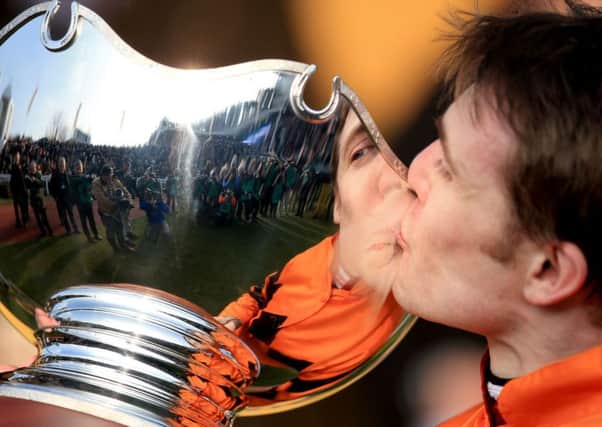 Tom Scudamore celebrates winning the Ryanair World Hurdle on Thistlecrack by kissing the trophy (Picture: Mike Egerton/PA).