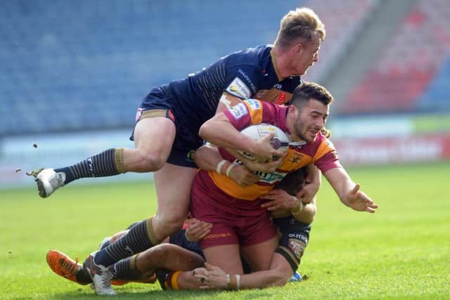 IN THE THICK OF IT: Huddersfields Joe Wardle, on his return from injury is tackled by the Hull KR defence in their Super League encounter. Picture: Simon Hulme