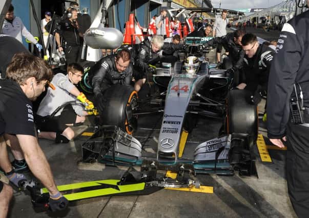 QUICK CHANGE: F1 champion Lewis Hamiltons car undergoes a tyre change during yesterdays second practice session. Pictures: Ross Land/AP.