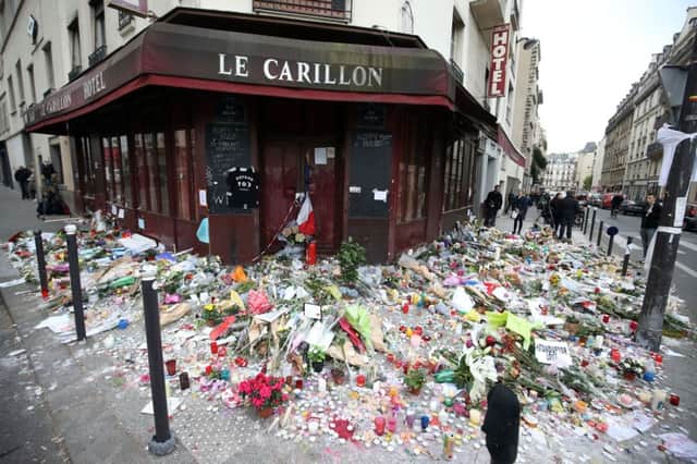Floral tributes outside Le Carillon bar in Paris following the terrorist attacks last November
