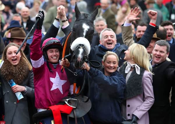 Don Cossack ridden by Bryan Cooper (centre) celebrates winning the Timico Cheltenham Gold Cup Chase with trainer Gordon Elliott (far right) and owner Michael O'Leary (second right) during Gold Cup Day of the 2016 Cheltenham Festival.