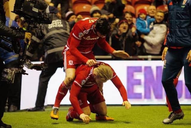 Middlesbrough's David Nugent (top) celebrates scoring his side's first goal of the game with team-mate Adam Clayton. Picture: PA.