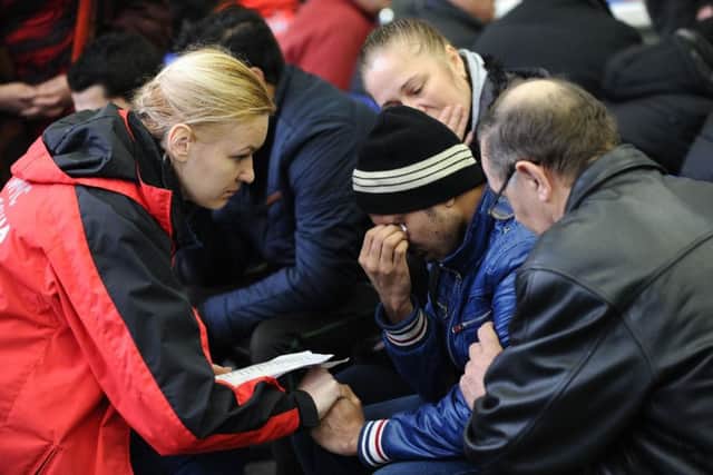 A Russian Emergency Situations Ministry employee, left, tries to comfort a relative of the plane crash victims at the Rostov-on-Don airport. (AP Photo)