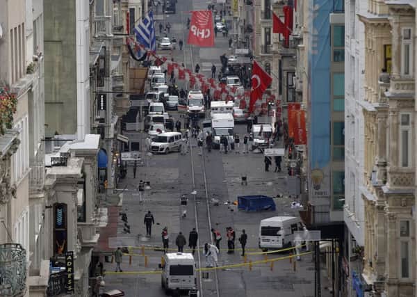 Emergency services at the scene of an explosion, on a street, in Istanbul, Turkey.  (AP Photo/Emrah Gurel)
