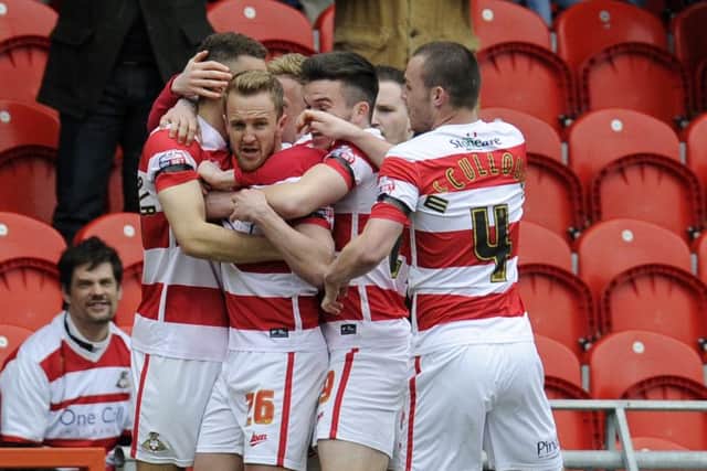 James Coppinger, second left, is congratulated by Doncaster Rovers team-mates after scoring the opening goal against Peterborough on his return from injury (Picture: Bruce Rollinson).