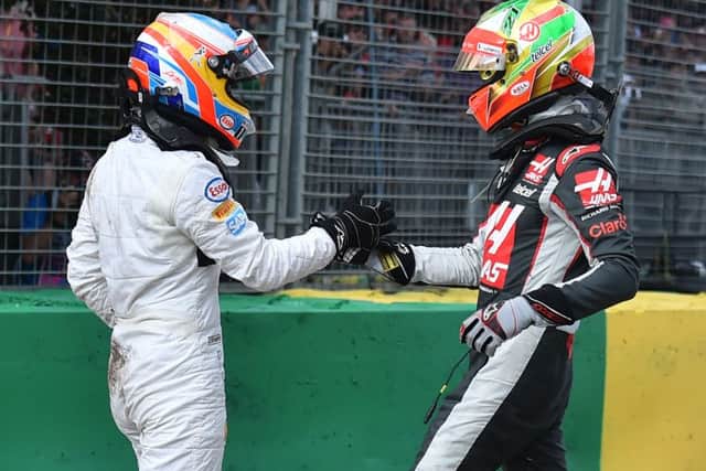 McLaren driver Fernando Alonso, left, of Spain and Haas driver Esteban Gutierrez of Mexico shake hands following their collision Picture: AP/Theo Karanikos.