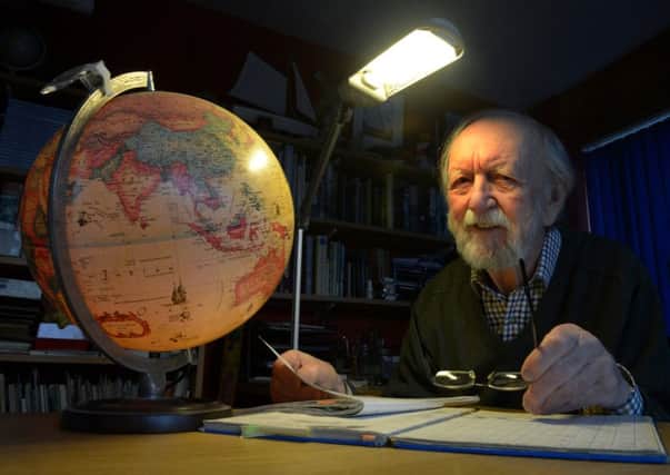 John Paul from Kirkbymoorside  looking at the route of his voyage on the globe.