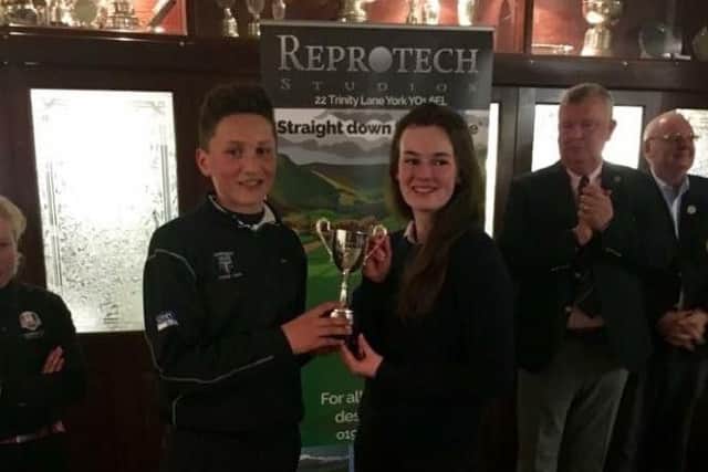 Captains Angus Gray (Harrogate Union) and Lucy Walker (York Union) with the Reprotech trophy after the 3-3 draw at Bedale GC.
