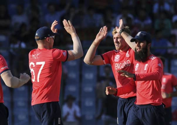 England's David Willey, second right, celebrates with team mates after claiming a wicket against Afghanistan in Delhi on Wednesday. Picture: AP/Manish Swarup.