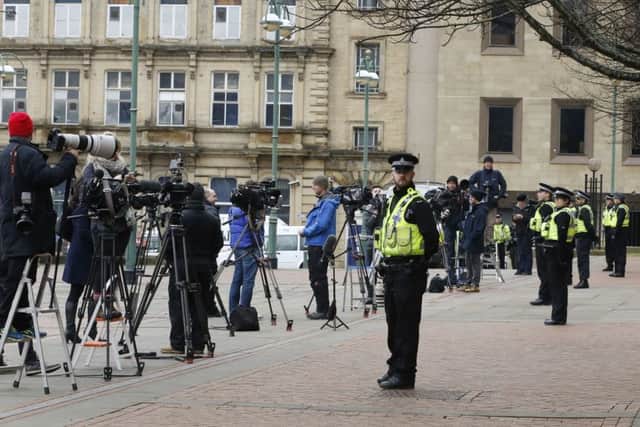 Media and police officers await the arrival of Adam Johnson at Bradford Crown Court
