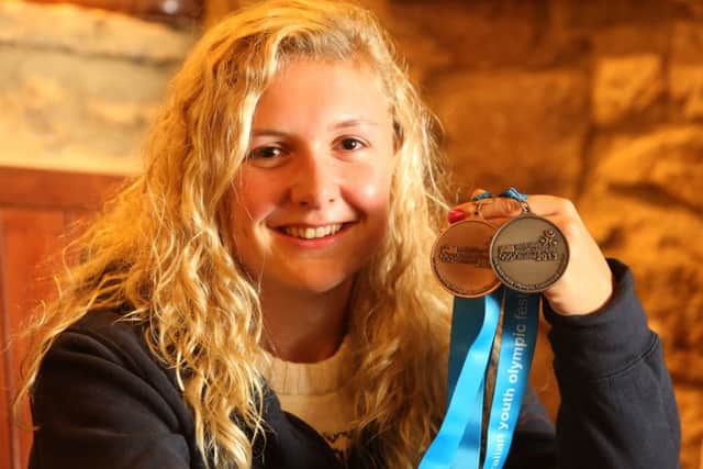 Jess Leyden, with her silver and bronze medals for rowing from the junior Olympics in 2013