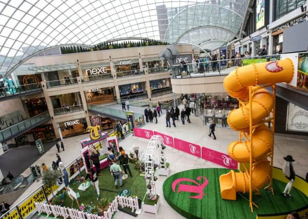 The huge yellow helter-skelter slide inside Trinity shopping centre in Leeds for Easter week celebrations.