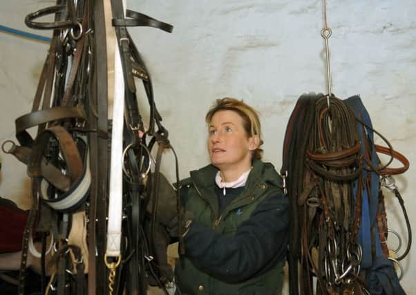 Jo Foster sorting out the tack at her stables at Menston near Leeds .