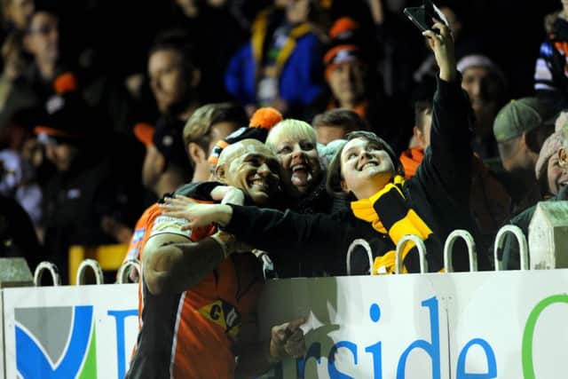 MAIN MAN: Jake Webster celebrates with Castleford fans on Thursday by helping take a pitchside selfie. Picture : Jonathan Gawthorpe