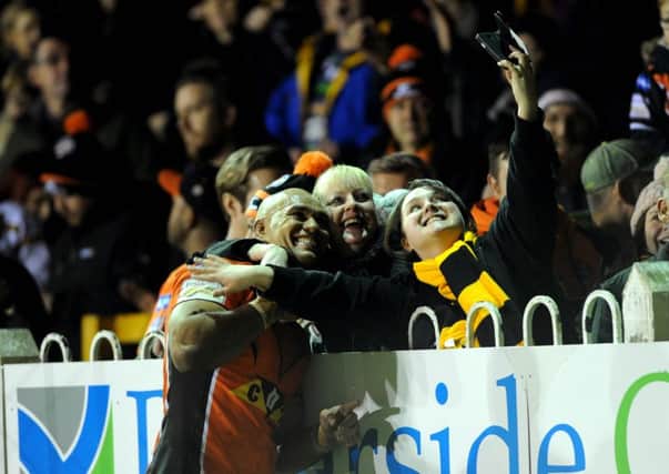 MAIN MAN: Jake Webster celebrates with Castleford fans on Thursday by helping take a pitchside selfie. Picture : Jonathan Gawthorpe