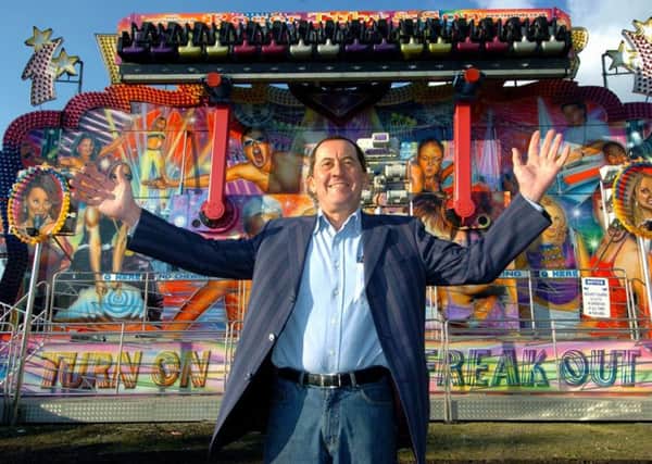 Roger Tuby infront of one of the rides at the Valentine's fun fair at Elland Road.
