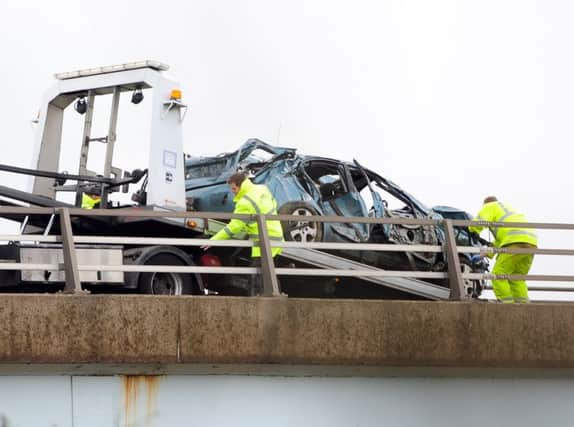 The scene in Sprotborough, South Yorkshire, where a Nissan car has crashed through a barrier of the A1M and landed in the River Don, killing its occupant. Picture: Ross Parry Agency